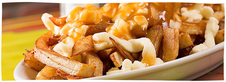 Frites, gravy and cheese in a plate, commonly called a poutine.